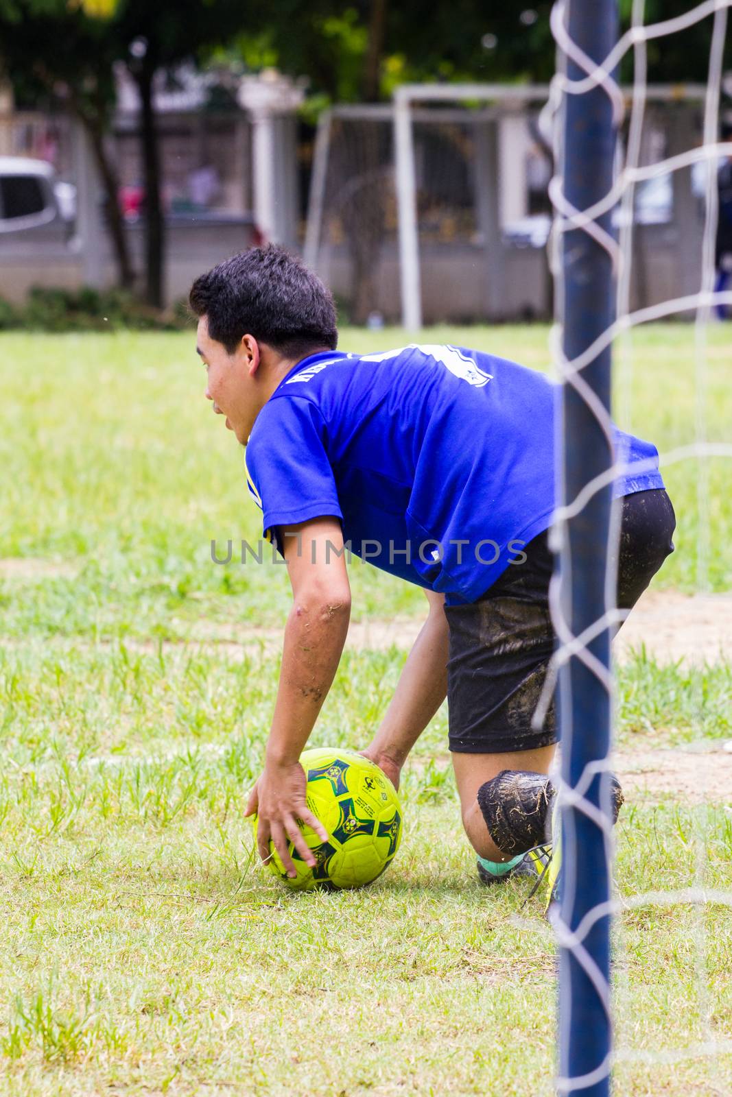 CHIANGRAI, THAILAND - AUG 9: unidentified male teenagers playing soccer in field on August 9, 2014 in Chiangrai, Thailand. Thai teenagers like to exercise by playing sports.
