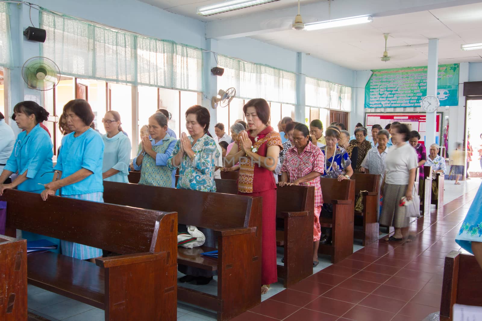 CHIANGRAI, THAILAND - AUG 10: unidentified people praying for Her Majesty Queen Sirikit in church on August 10, 2014 in Chiangrai, Thailand. Thai people in every religions always pray for the Queen in the occation of Her Mejesty Queen's Birthday (on August, 12)