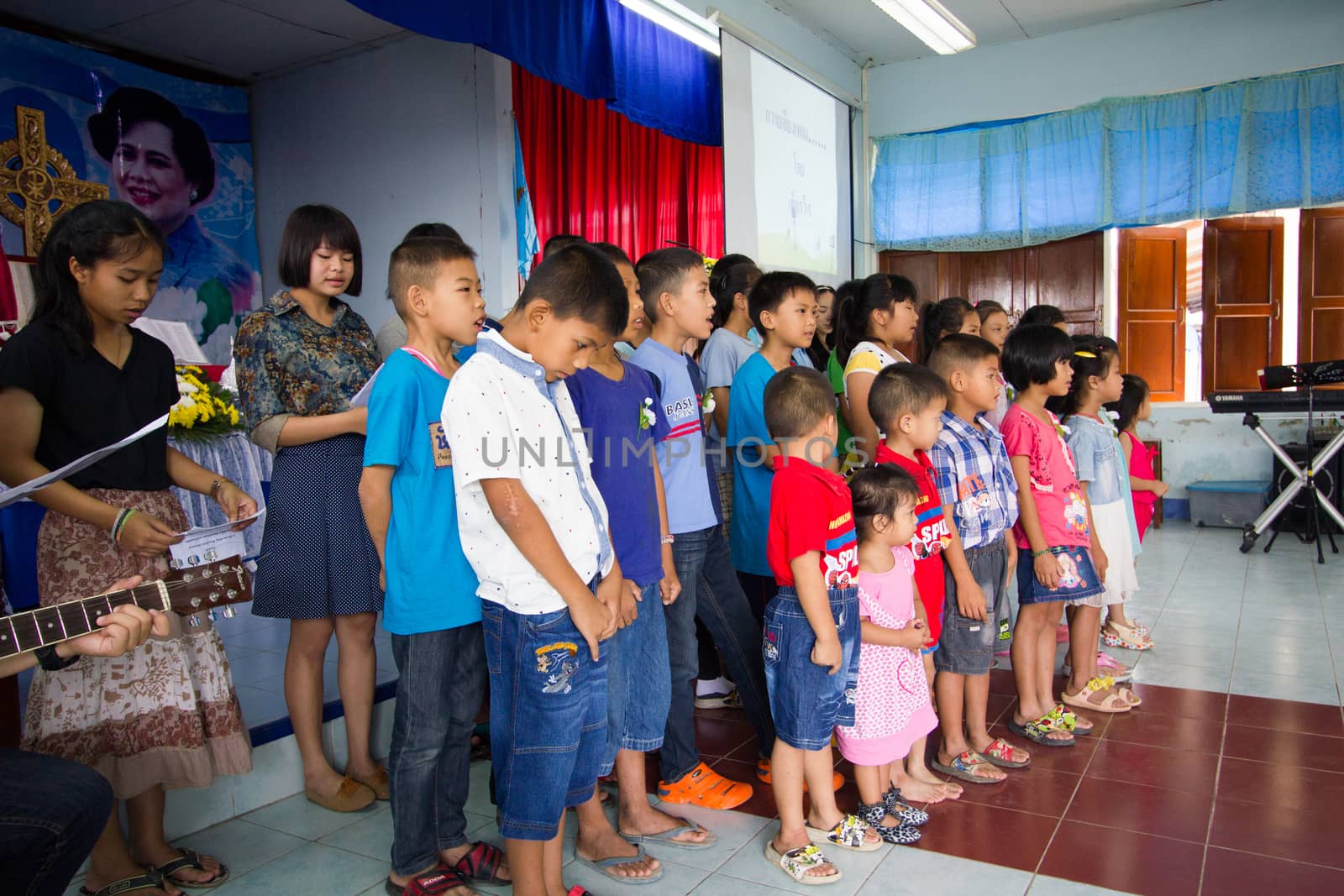 CHIANGRAI, THAILAND - AUG 10: unidentified children singing for Her Majesty Queen Sirikit in church on August 10, 2014 in Chiangrai, Thailand. Thai people in every religions always pray for the Queen in the occation of Her Mejesty Queen's Birthday (on August, 12)
