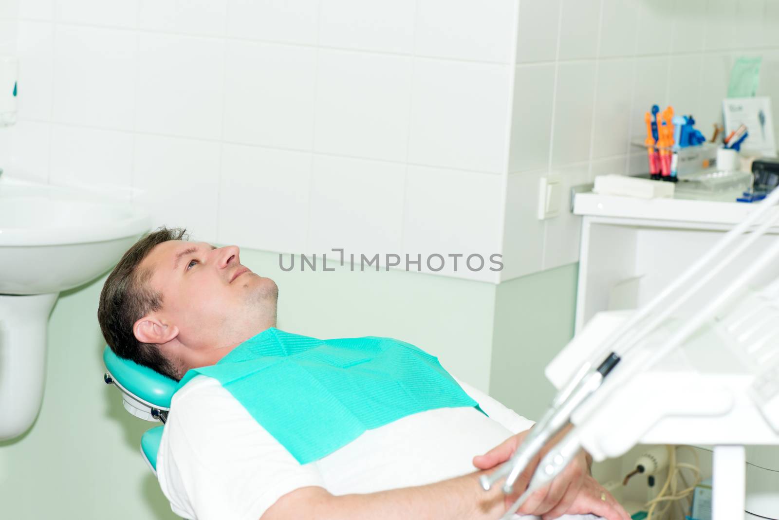 Portrait of men in dentist office by Nanisimova