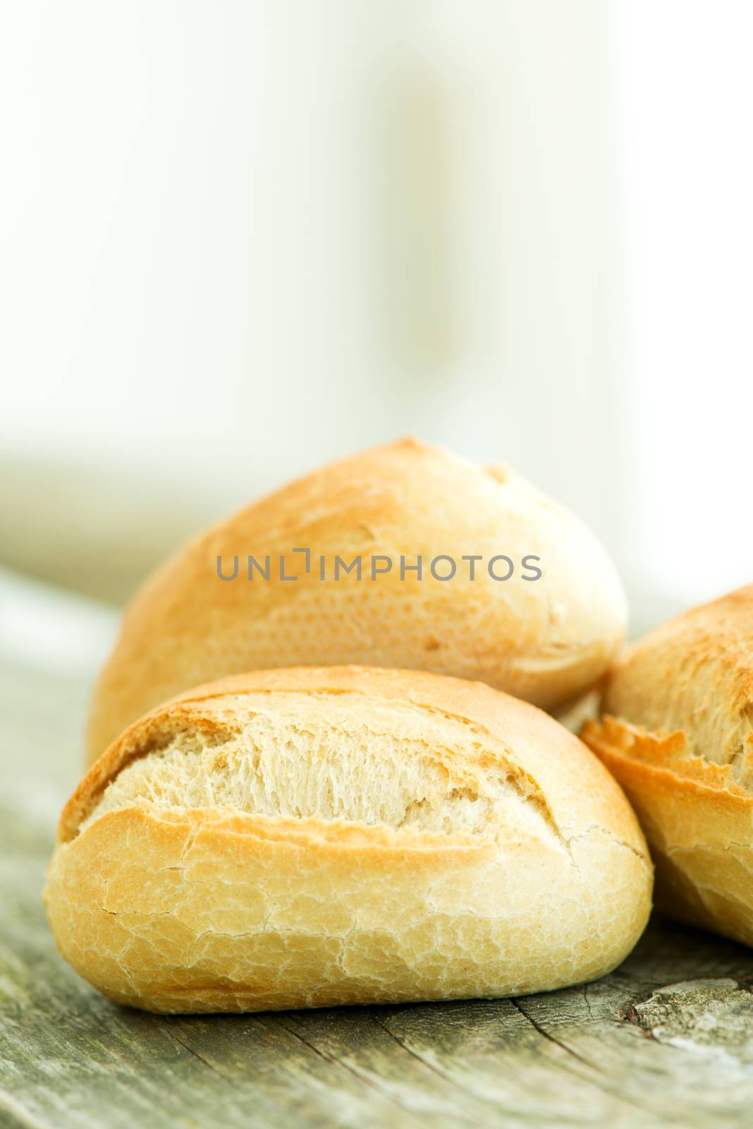 Bread on wooden table copy space by Nanisimova