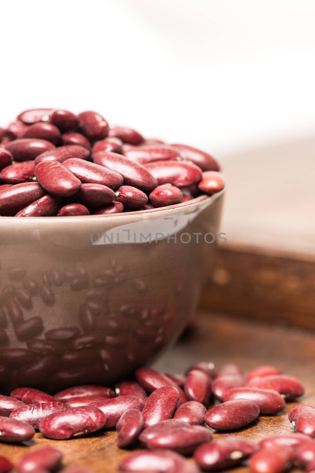 Bowl with raw red beans closeup vertical by Nanisimova