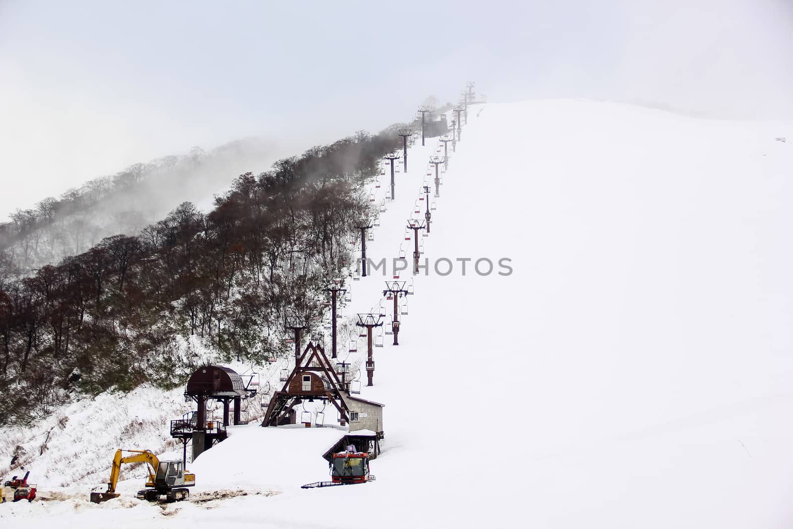 Ski chair lift with skiers on mountain