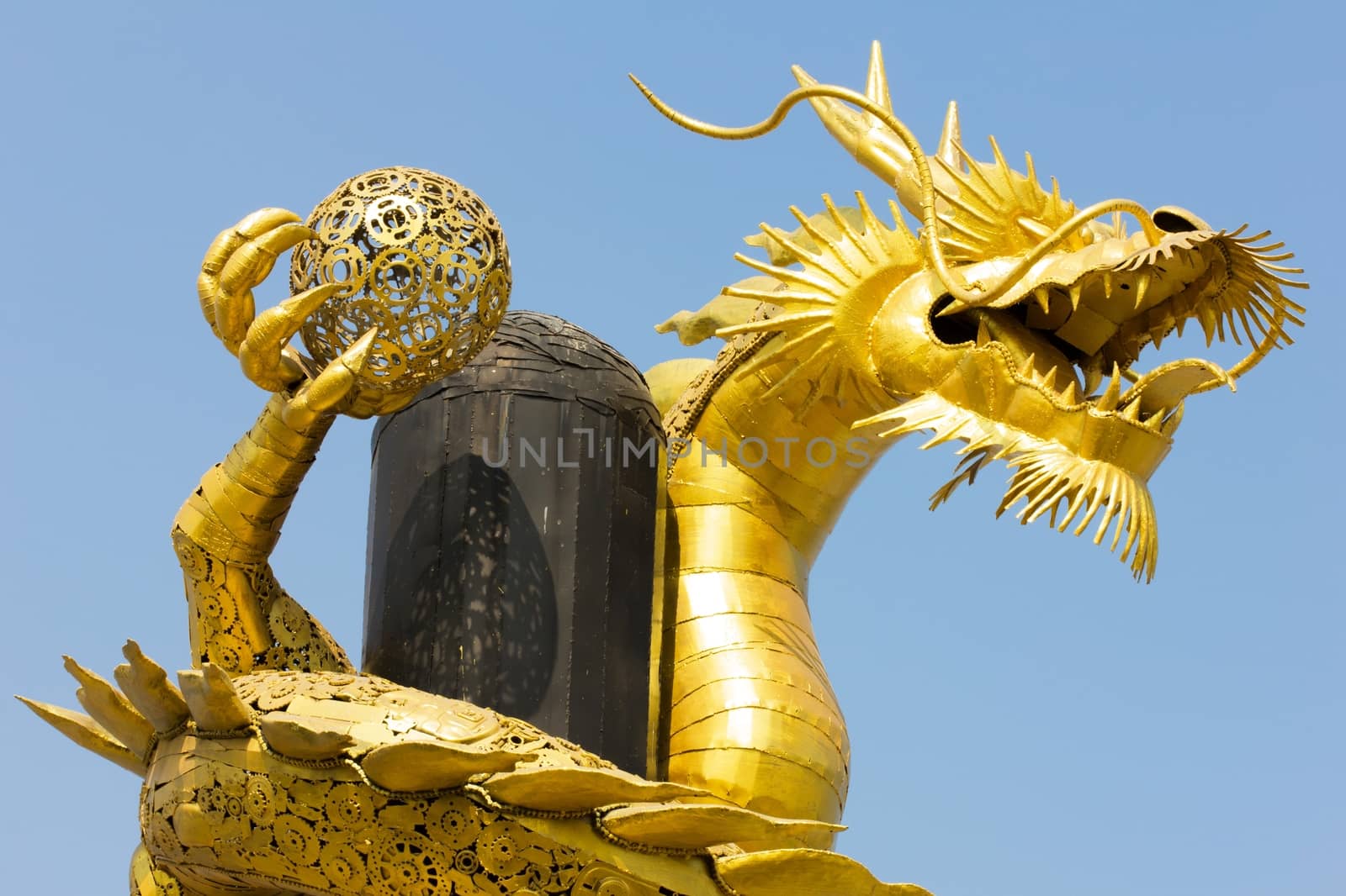 Giant golden Chinese dragon on clear blue sky