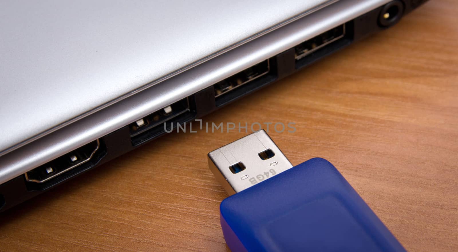 usb store with laptop on wooden background