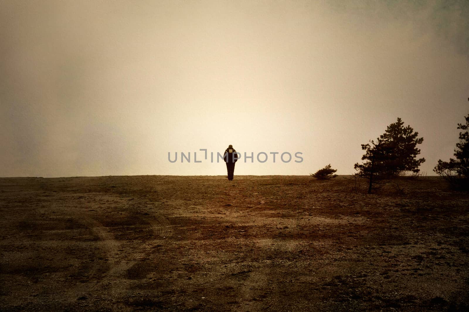 Image textured with soft sandstone of human walking alone on a moor.