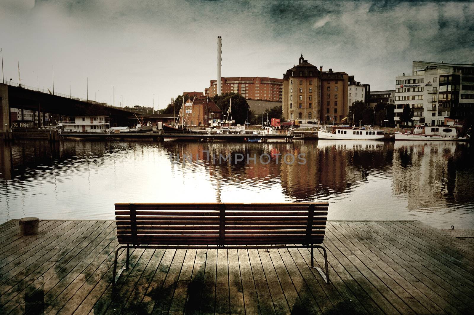 Textured image of empty bench by the water in Stockholm, Sweden, 