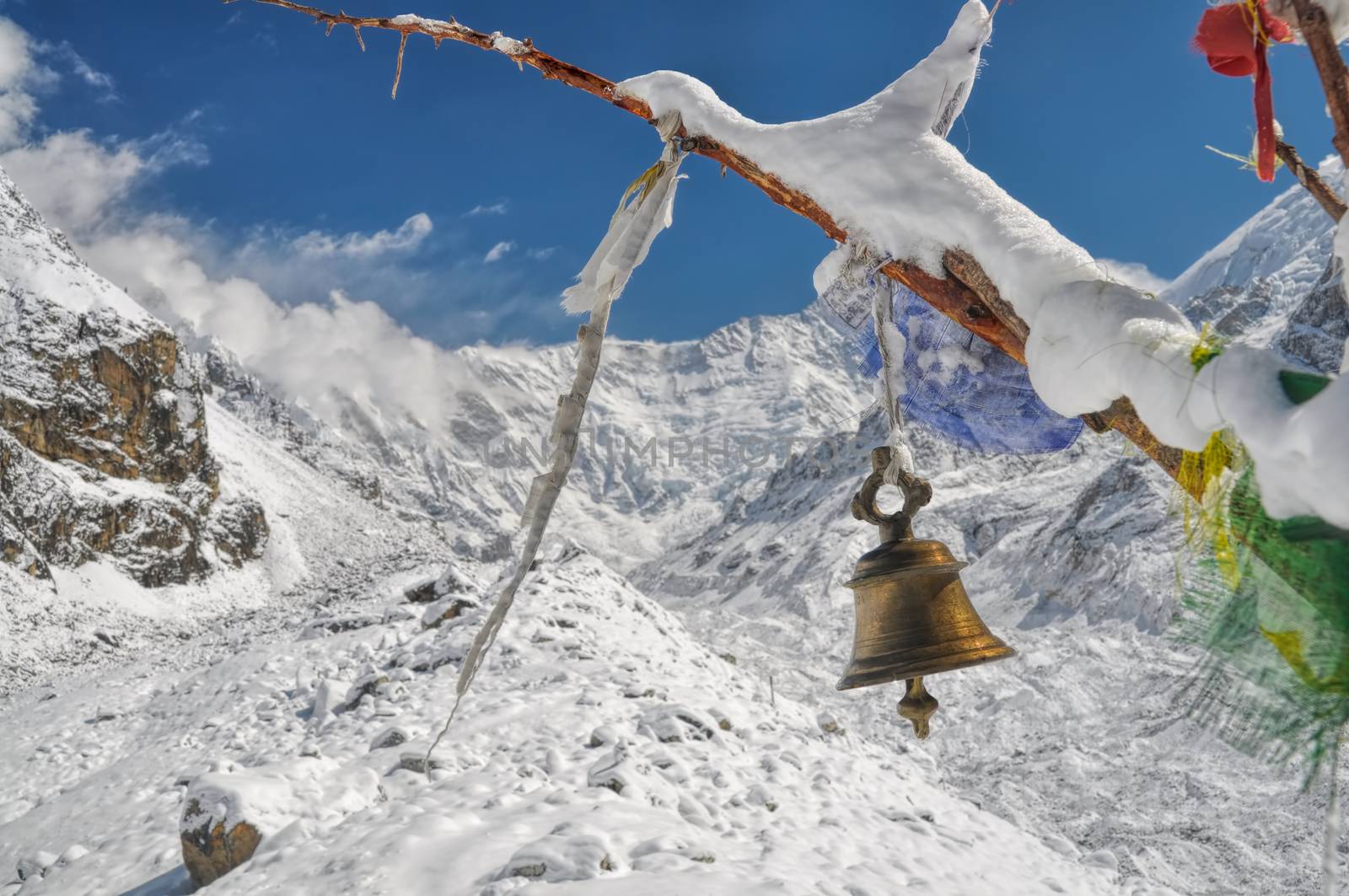 Buddhist bell and prayer flags in Himalayas near Kanchenjunga, the third tallest mountain in the world