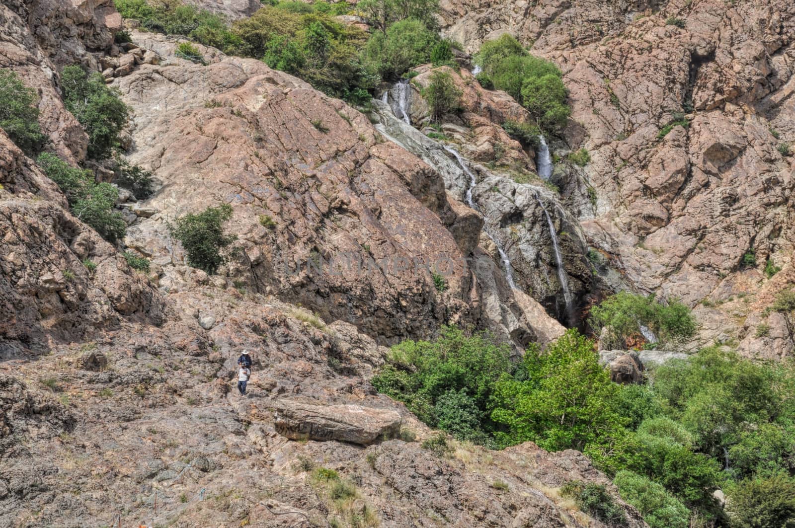 Water cascading down the scenic rocky slopes in Tochal, Iran