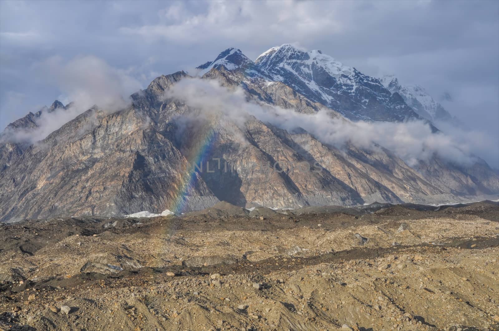 Rainbow forming above Engilchek glacier in Tian Shan mountain range in Kyrgyzstan