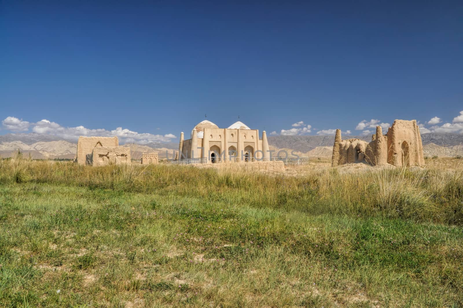 Ruins of ancient temple on green grasslands in Kyrgyzstan