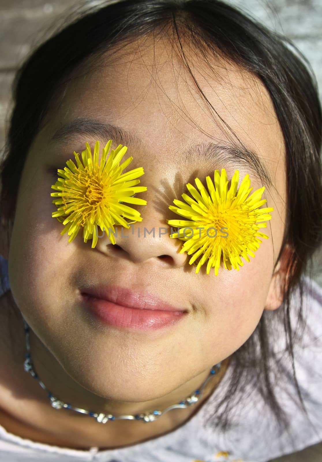 Girl playing with yellow flowers