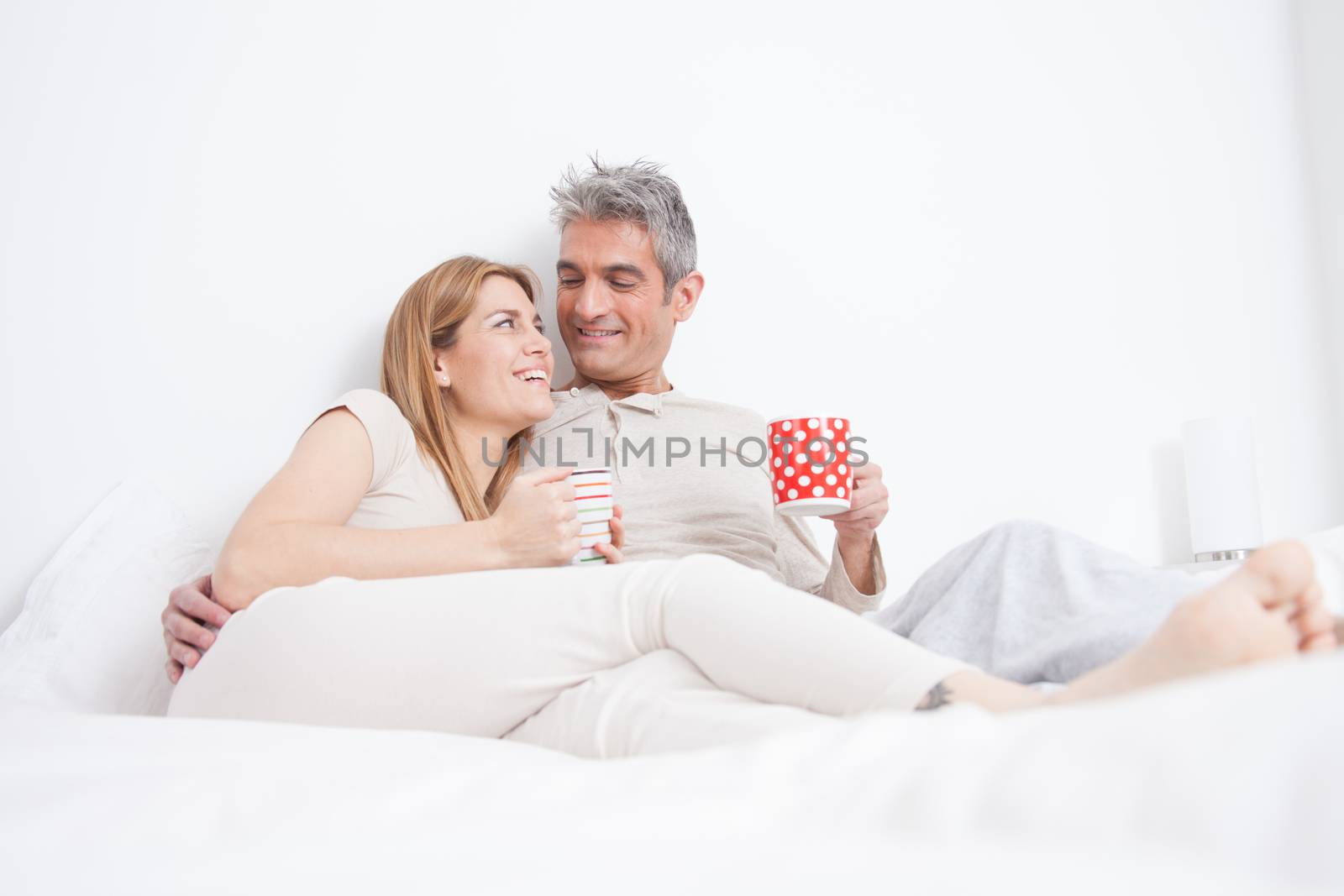 25-30, adult, apartment, attractive, bed, bedroom, caucasian, coffee, Couple, fun, handsome, happy, home, horizontal, house, leisure, lifestyle, love, marriage, men, model, nightwear, old, pc, people, person, property, releases, sitting, smile, tablet, tea, two, women, years, young