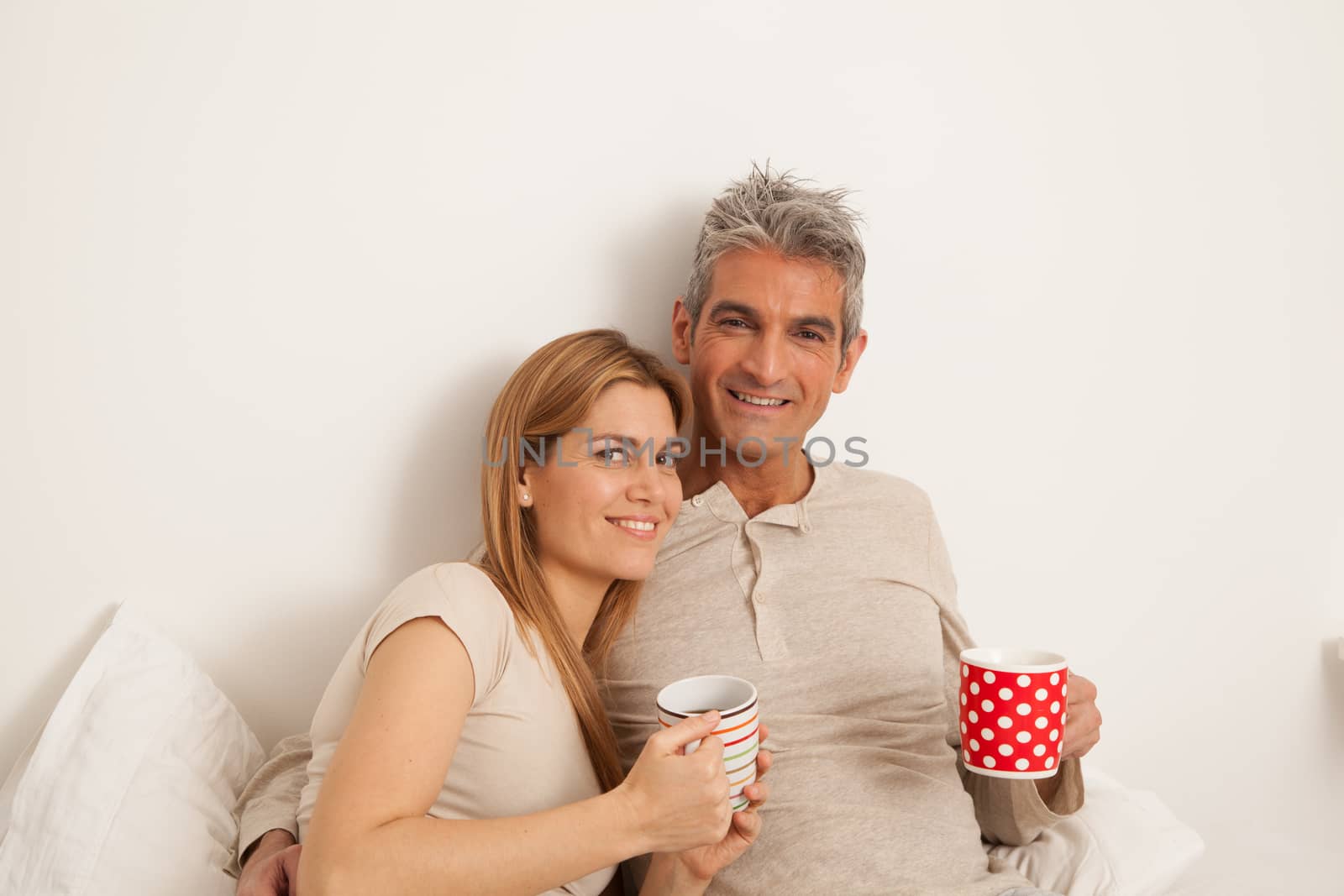 25-30, adult, apartment, attractive, bed, bedroom, caucasian, coffee, Couple, fun, handsome, happy, home, horizontal, house, leisure, lifestyle, love, marriage, men, model, nightwear, old, people, person, property, releases, sitting, smile, tea, two, women, years, young