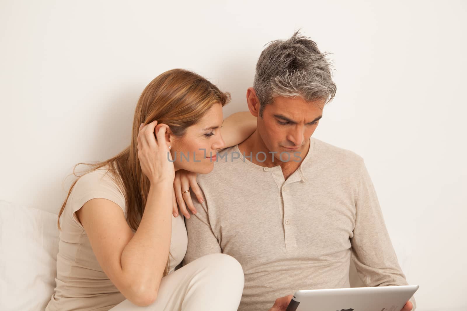 25-30, adult, apartment, attractive, bed, bedroom, caucasian, Couple, fun, handsome, happy, home, horizontal, house, leisure, lifestyle, love, marriage, men, model, nightwear, old, pc, people, person, property, releases, sitting, smile, tablet, two, women, years, young