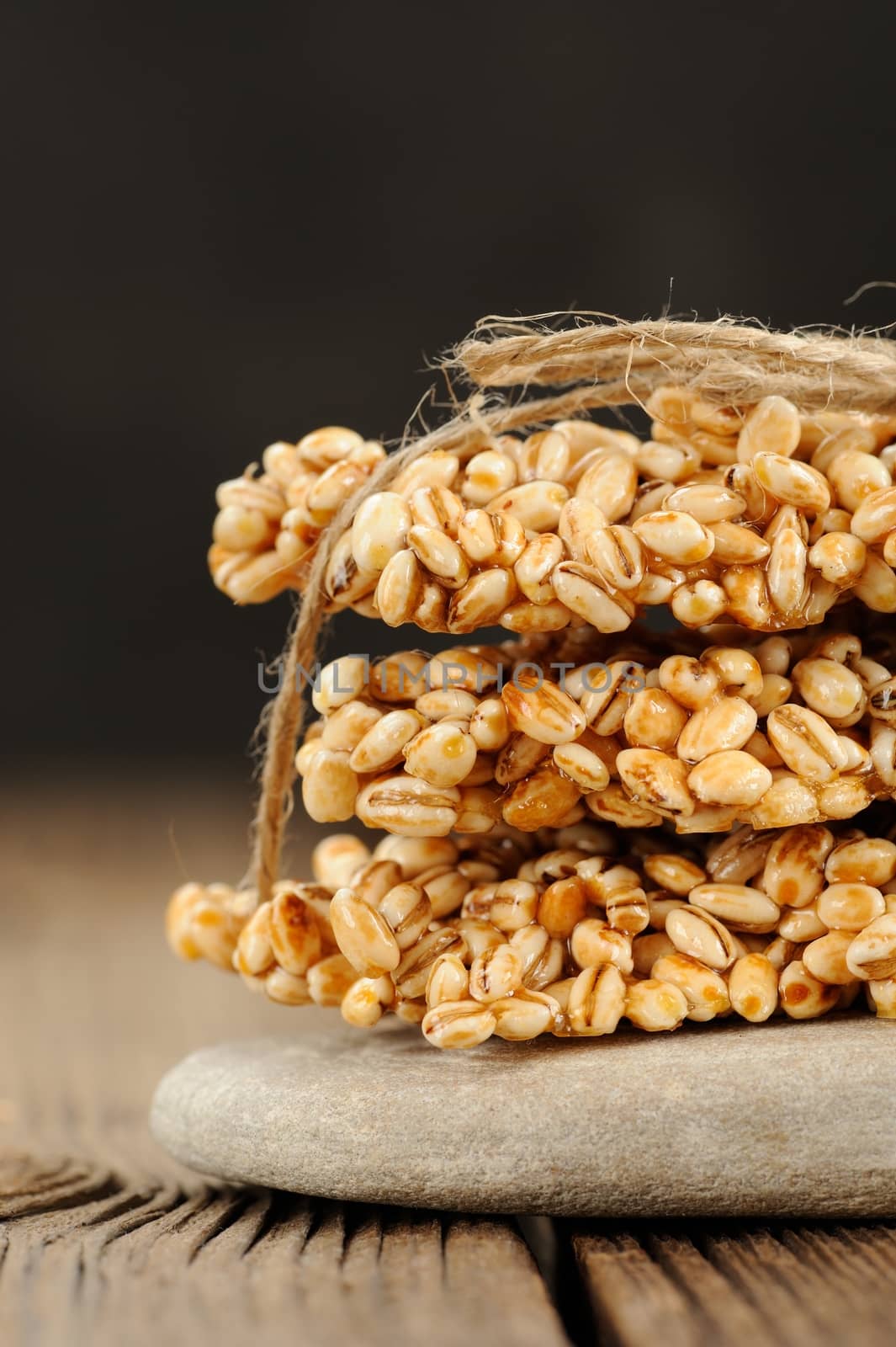 Barley granola bars in pile on rock closeup macro vertical