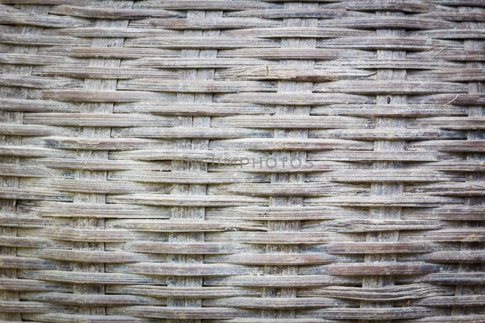 Close up detail view of a wicker basket weave with natural materials and stain fungi, vignette