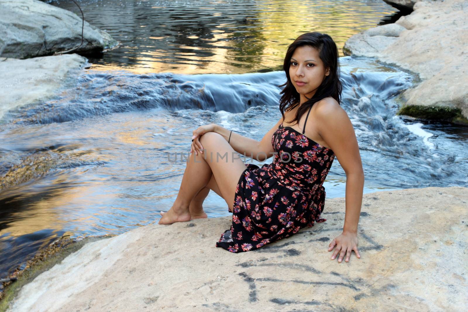 Young Hispanic woman near a creek.