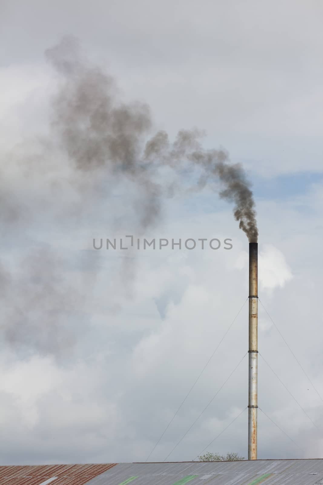 smoke from chimney of rice mill in thailand