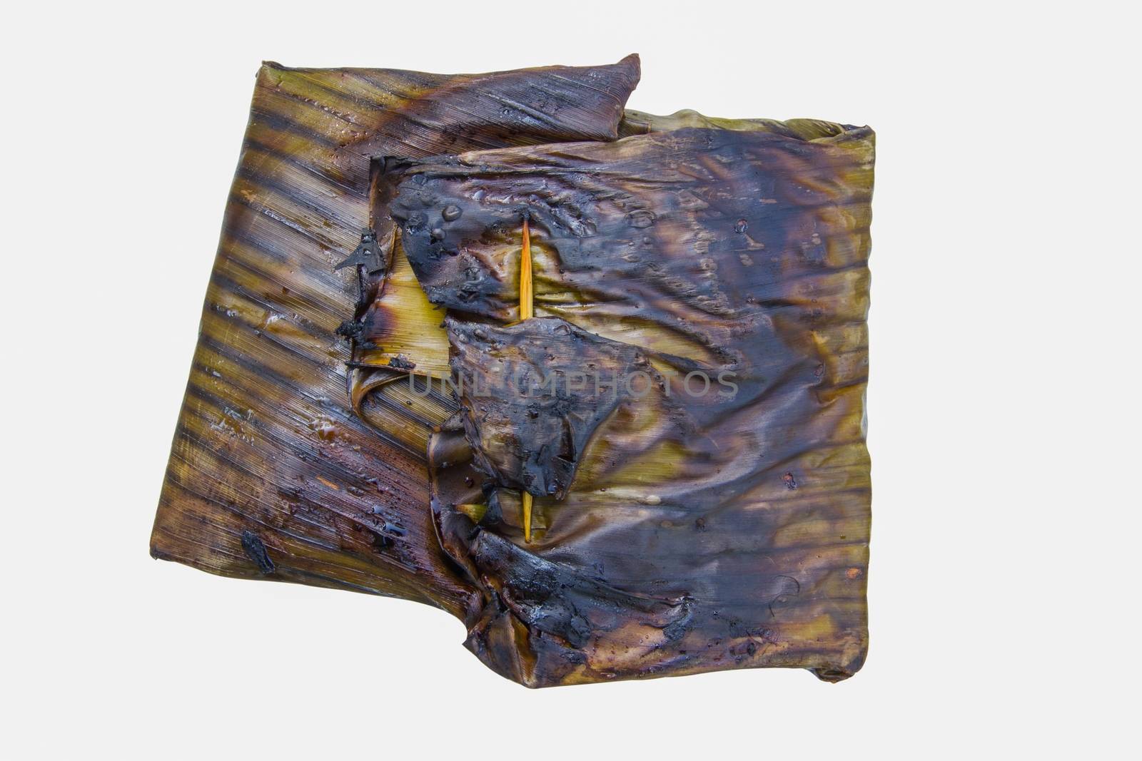 steamed fish with curry paste in banana leaves wrap (thai food) isolated on white background