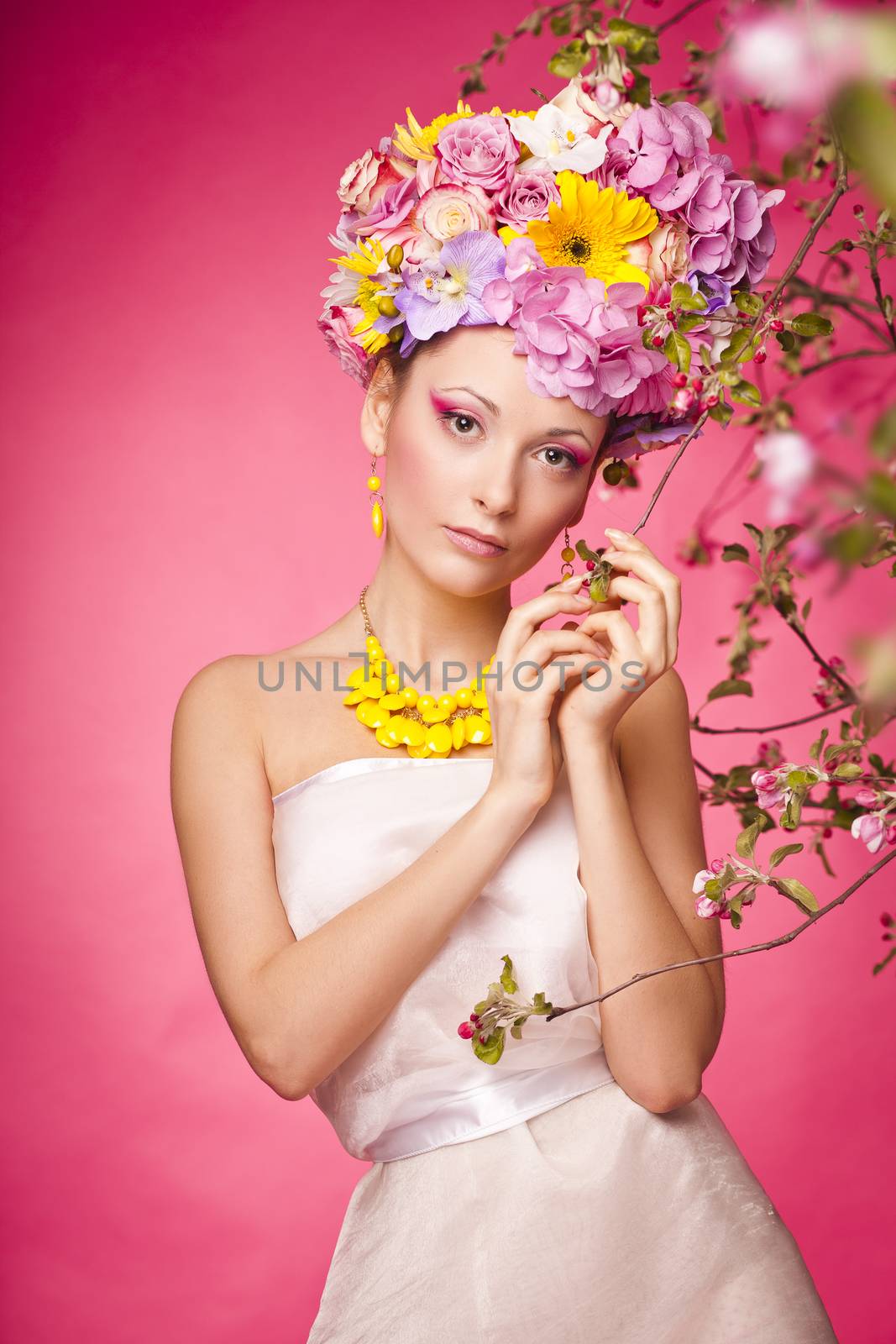 Young lady on a pink background with flower crown