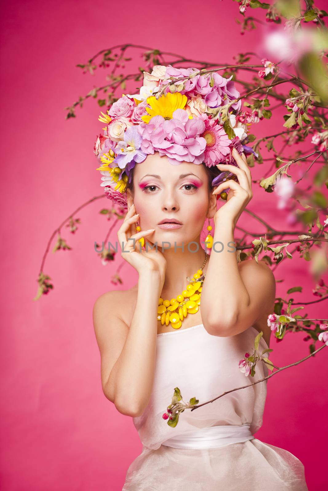 Woman standing under apple tree flowers. Plastic jewerly