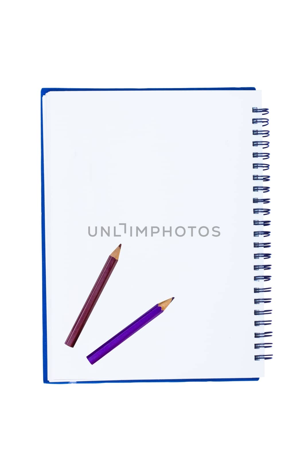 blank notebook with metal spiral and two crayons isolated on white background