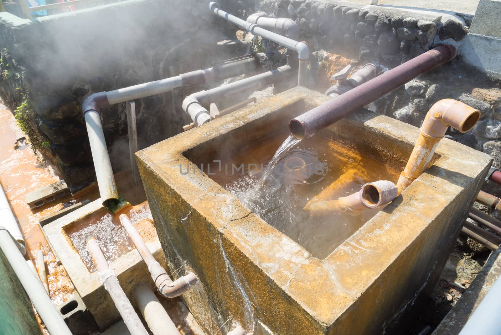 Hot water flowing out of pipe, hot spring water boiling, Beppu, Oita, Japan