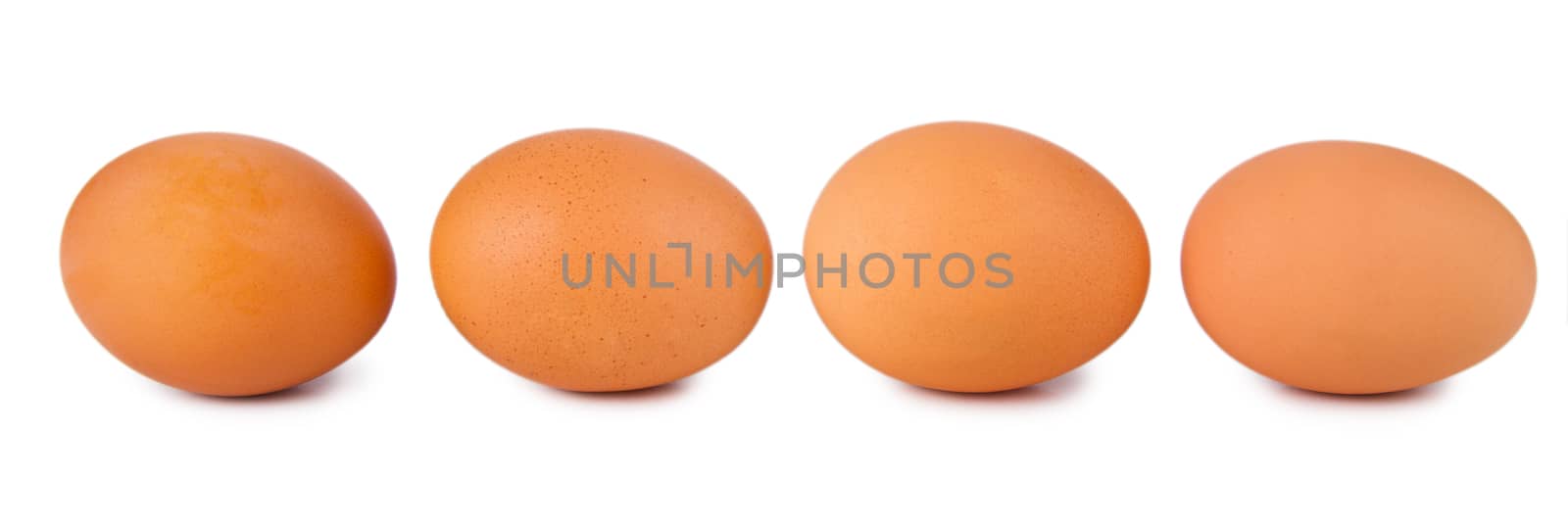 Four fresh brown eggs isolated on a white background