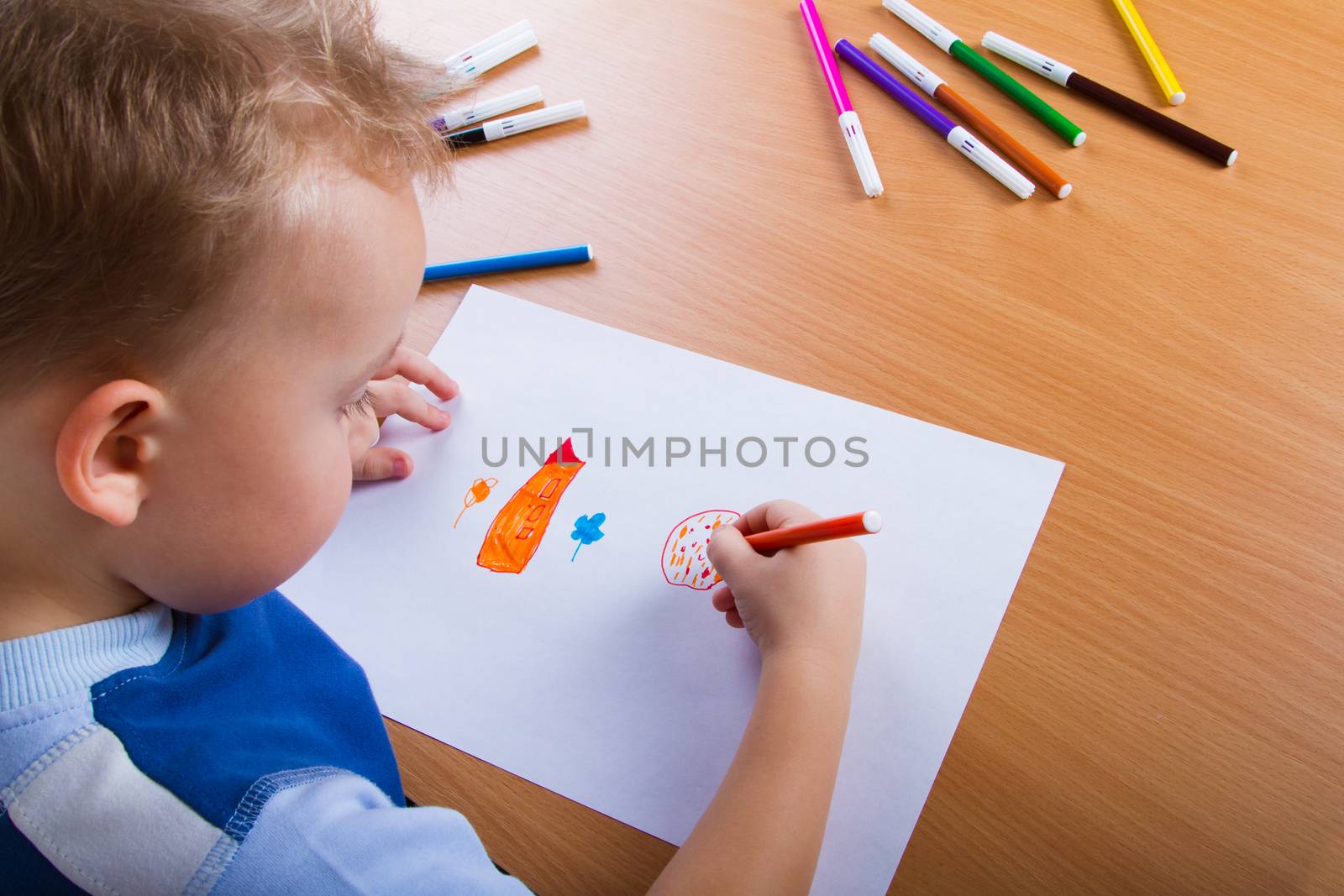 Small boy draws by grigorenko
