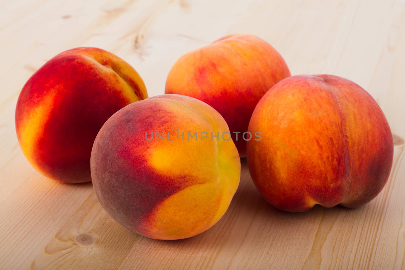 Fresh peaches on a light wood background