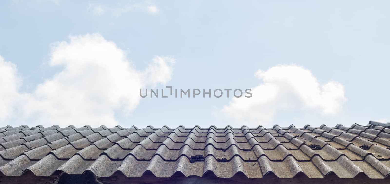 roof of house in cloudy sky as background.