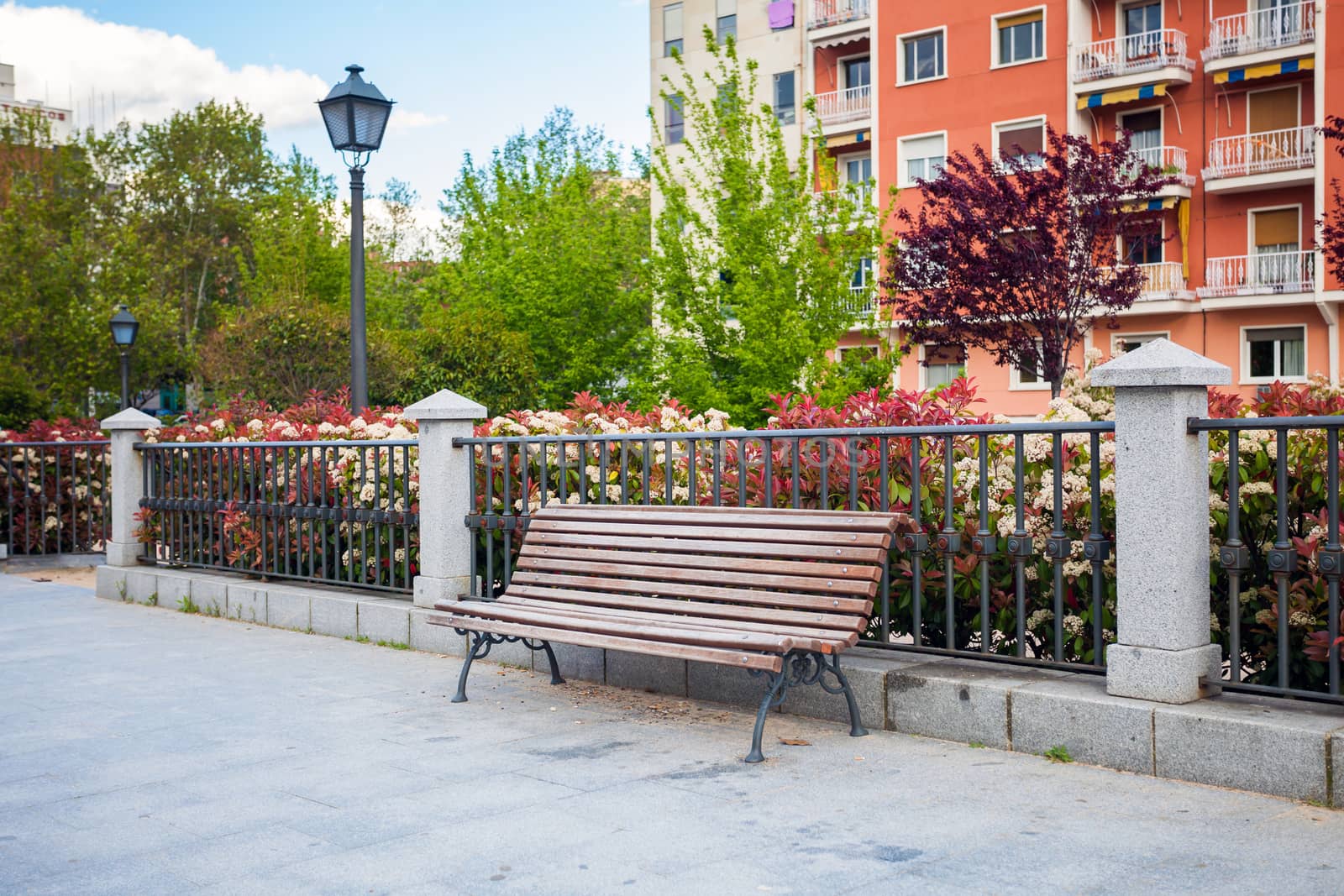 Bench in front of a typical residatial building in La Latina, Madrid, Spain
