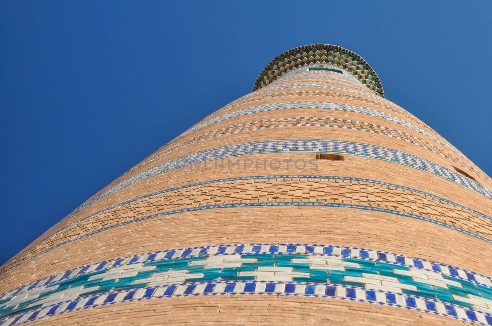 Facade of tall minaret in town of Khiva in Uzbekistan