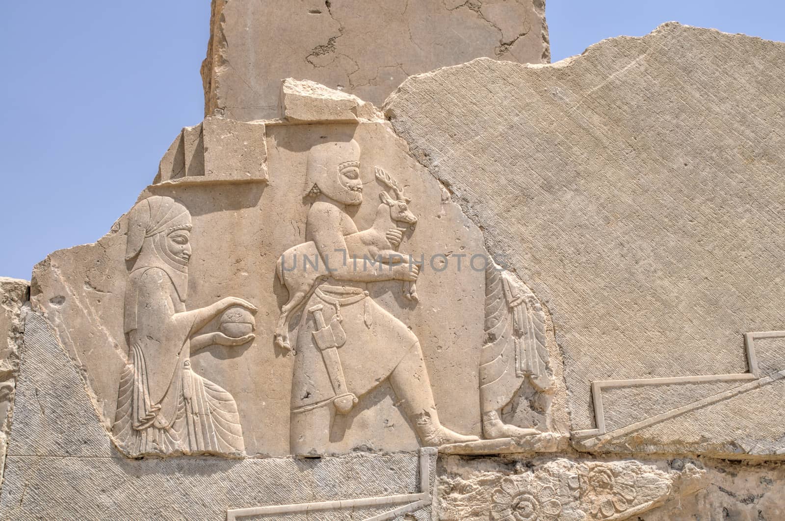 Figures on walls of ancient persian capital Persepolis in current Iran
