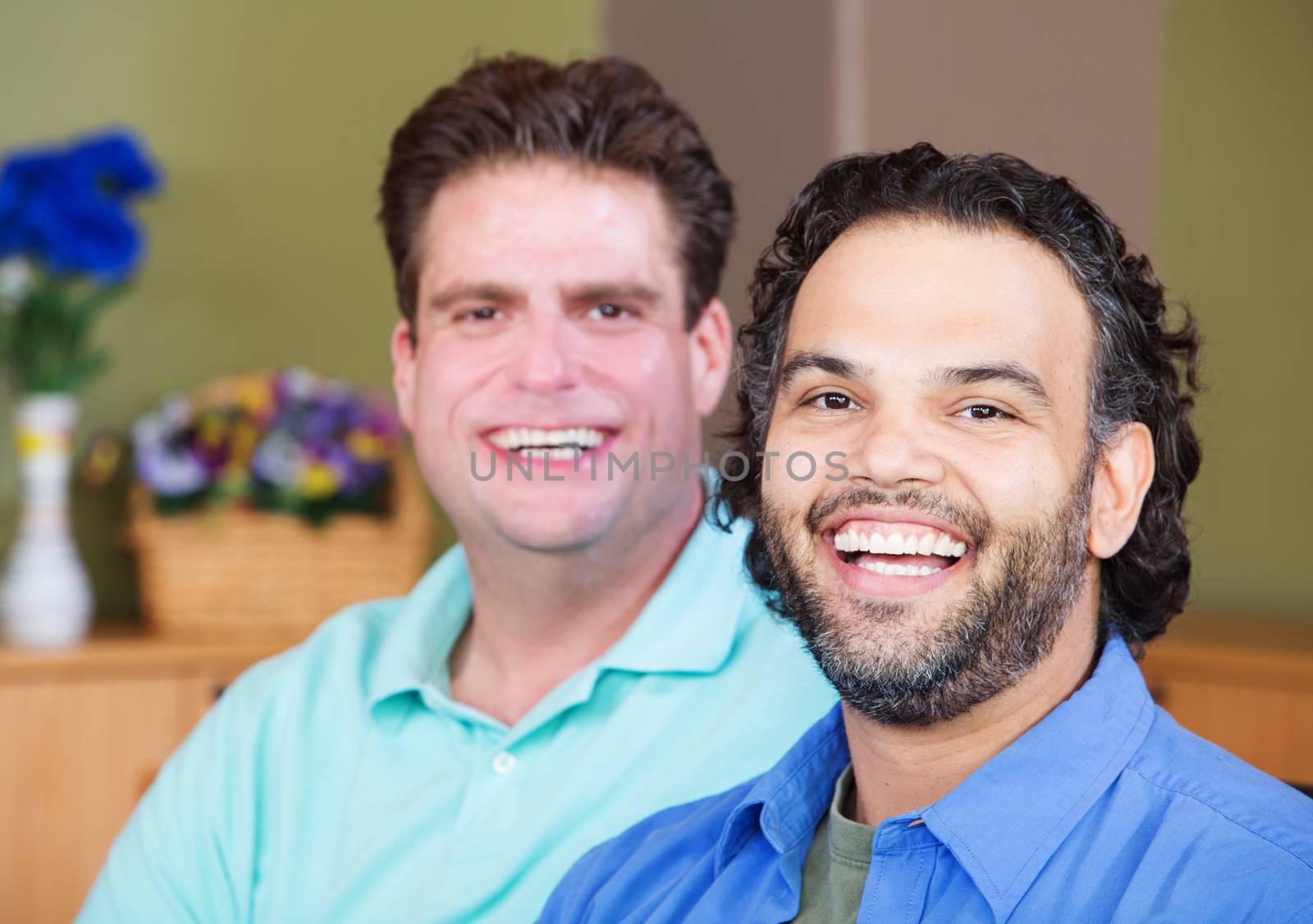 Mixed pair of laughing homosexual men