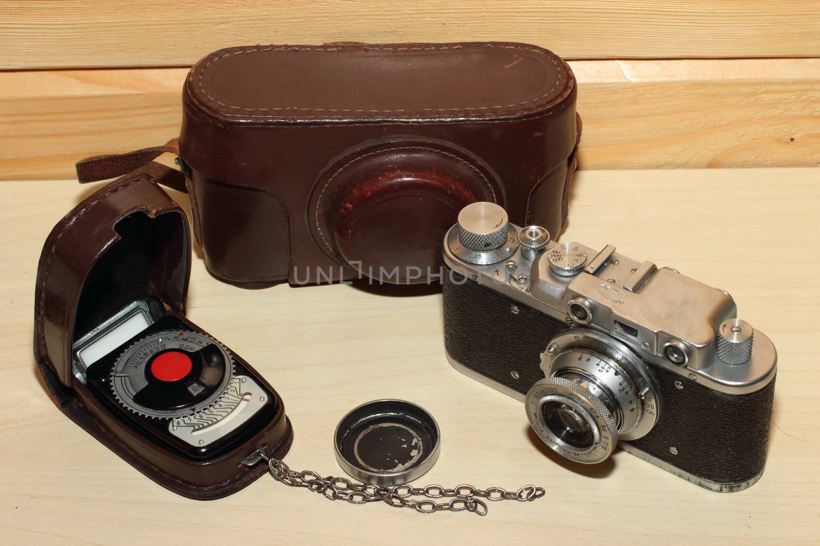 Vintage camera on a wooden background. light meter