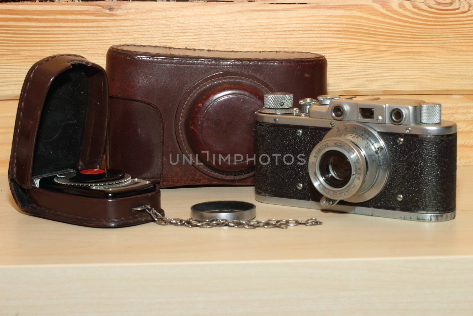 Vintage camera on a wooden background. light meter