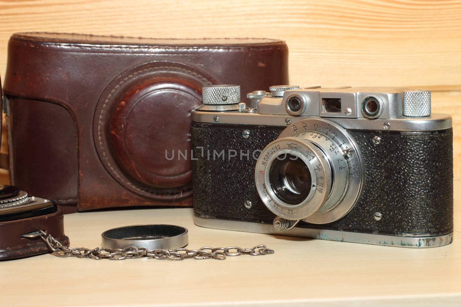 Vintage camera on a wooden background. light meter