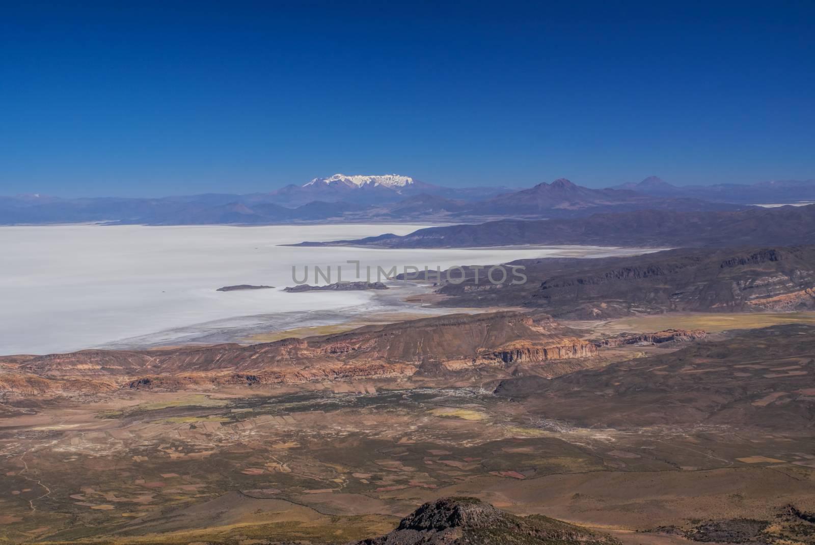 Aerial view of colored mountains and salt plane Salar de Uyuni in Bolivia
