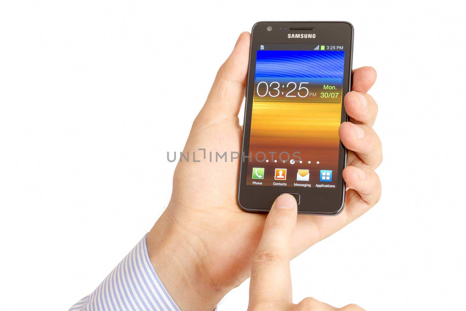 Galati, Romania – July 30, 2012: Hand holding the Samsung Galaxy S2. Samsung Galaxy S2 who has been sold in more than 20 million copies worldwide. Samsungs phone run the latest version of Android, Ice Cream Sandwich, the mobile operating system created by Google.