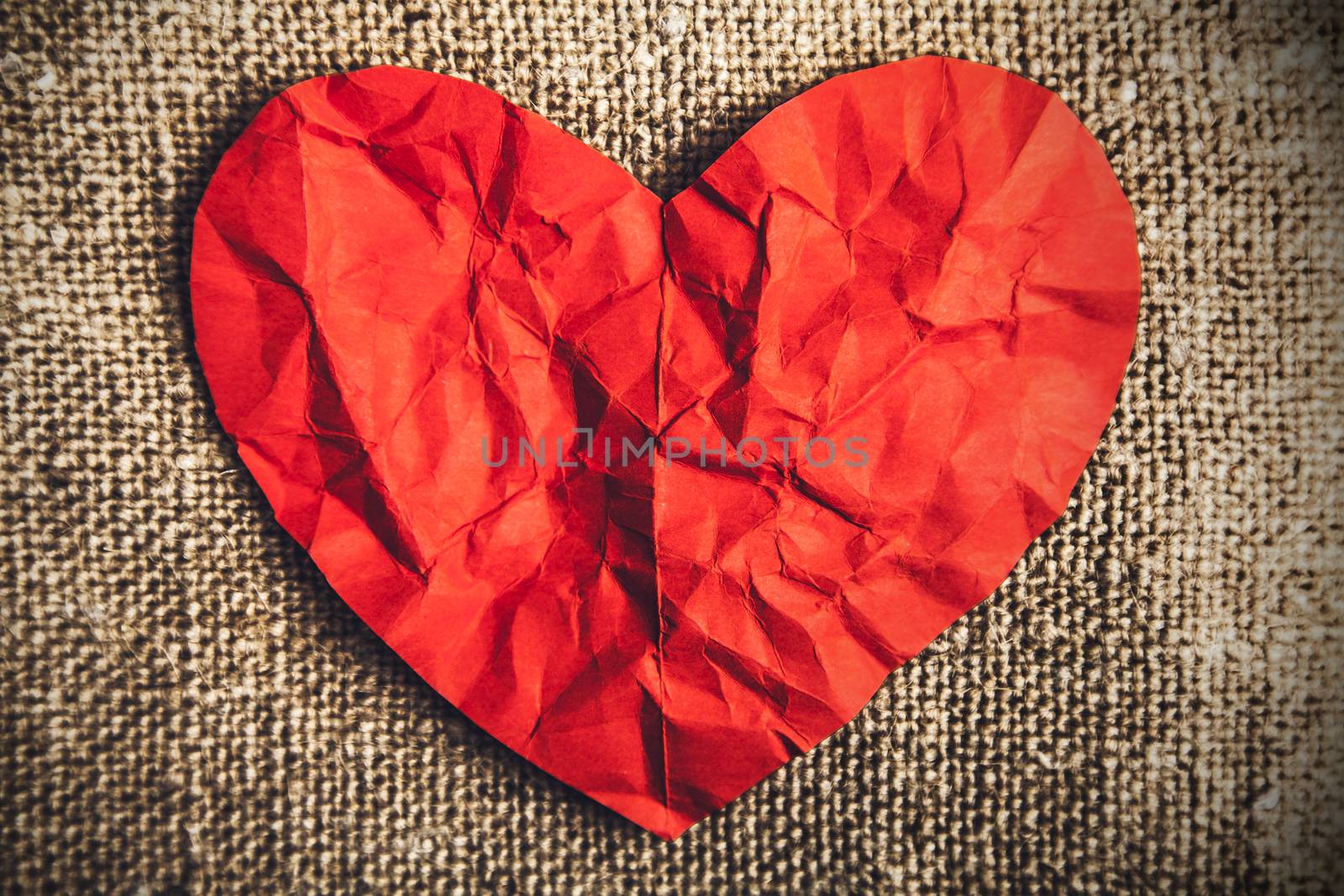heart of red paper on canvas