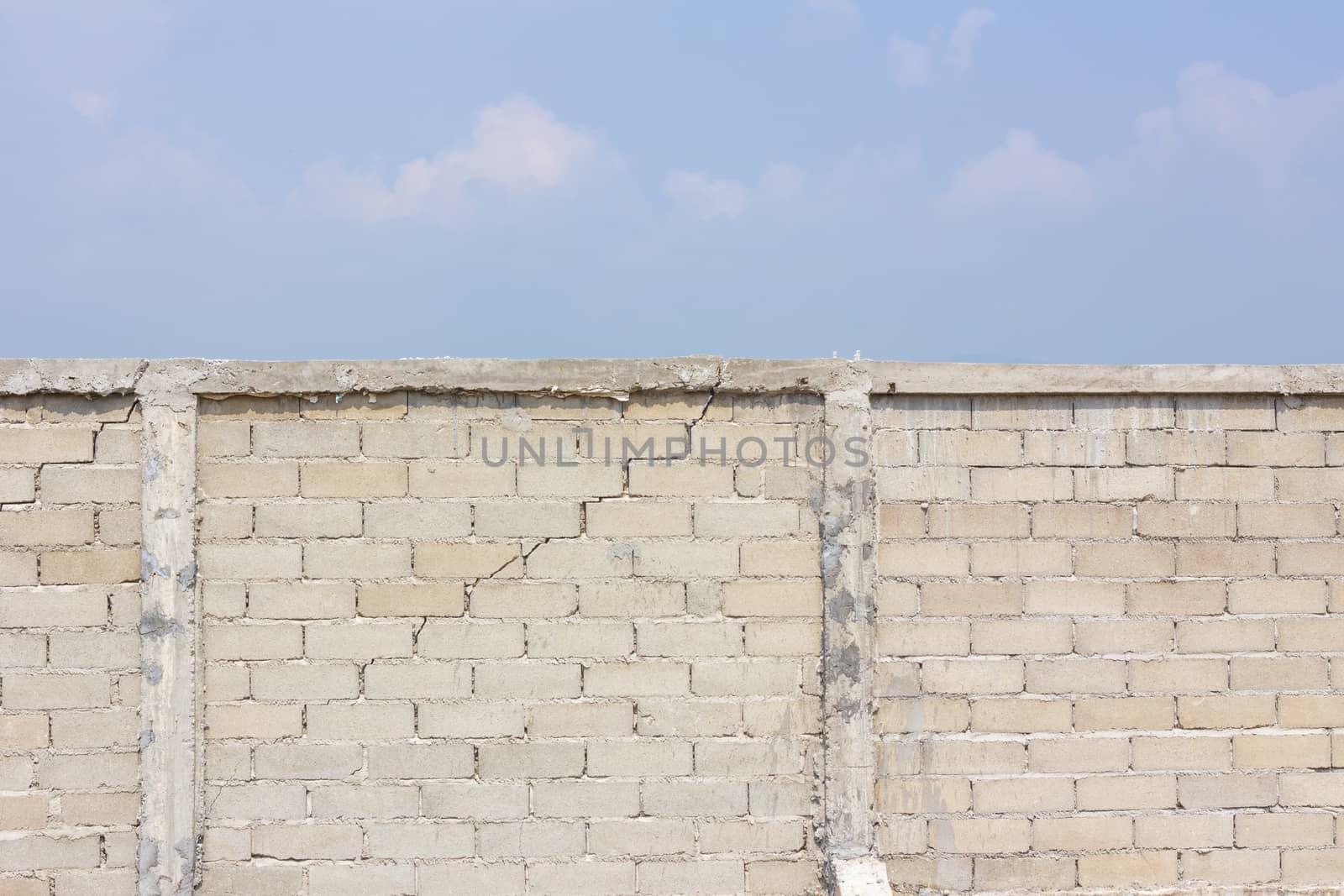 cracked wall in the background of cloud and sky.