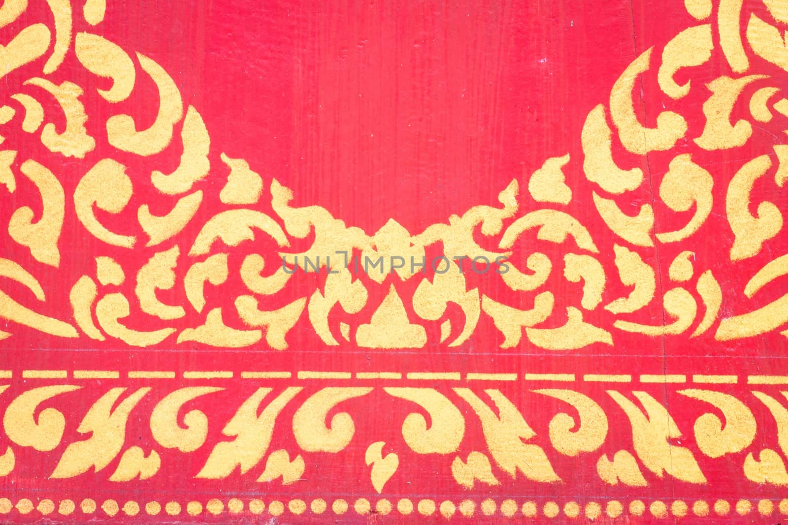 abstract golden pattern on red wall.