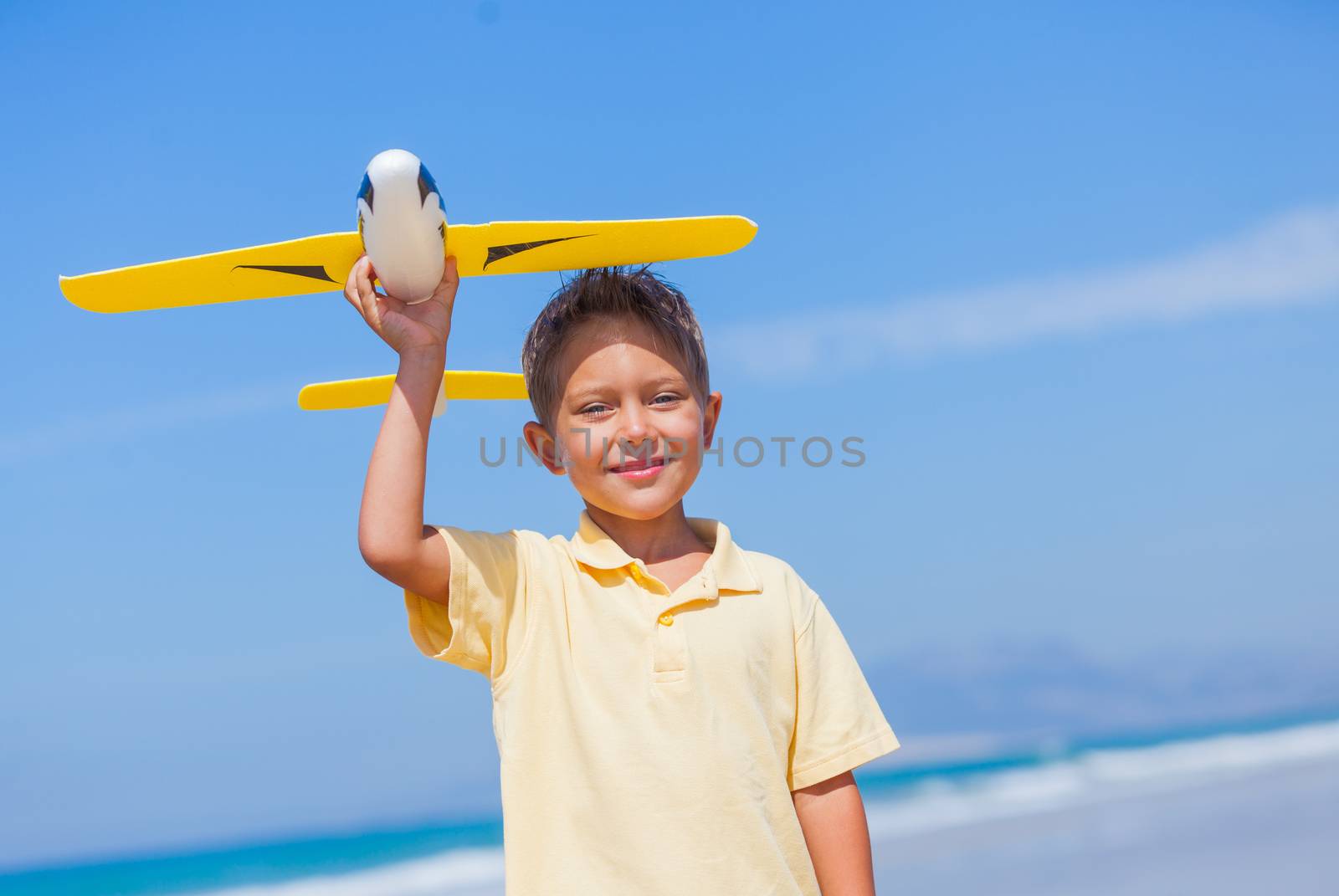 Portrait of beach kid boy kite flying outdoor coast ocean