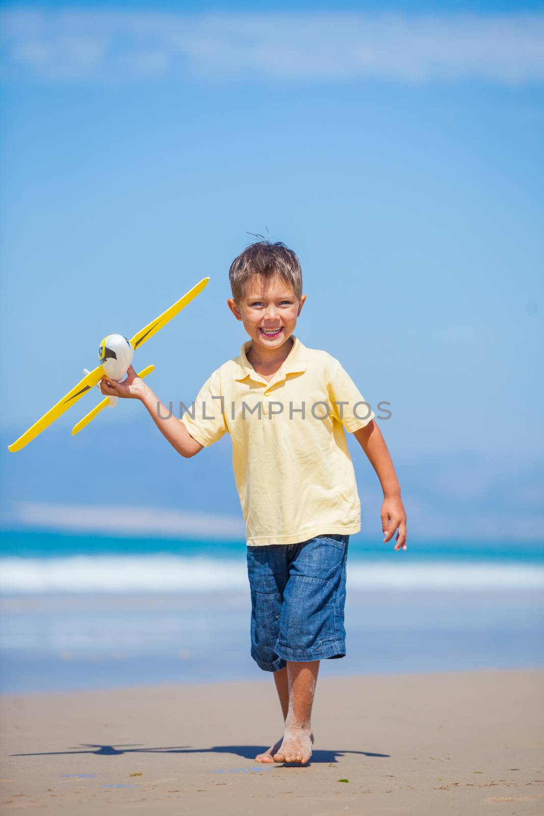 Beach kid boy kite flying outdoor coast ocean