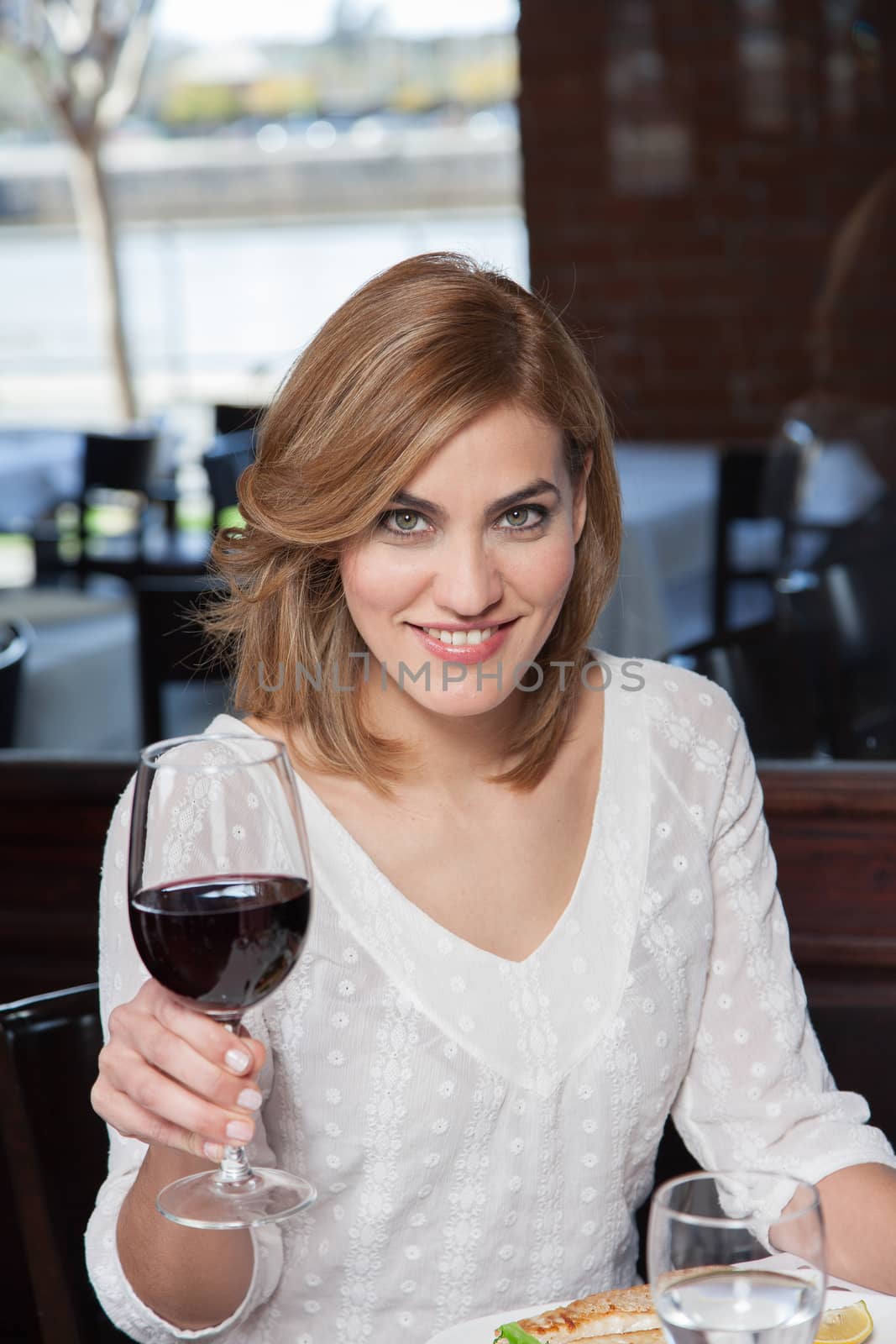 Smiling woman making a toast