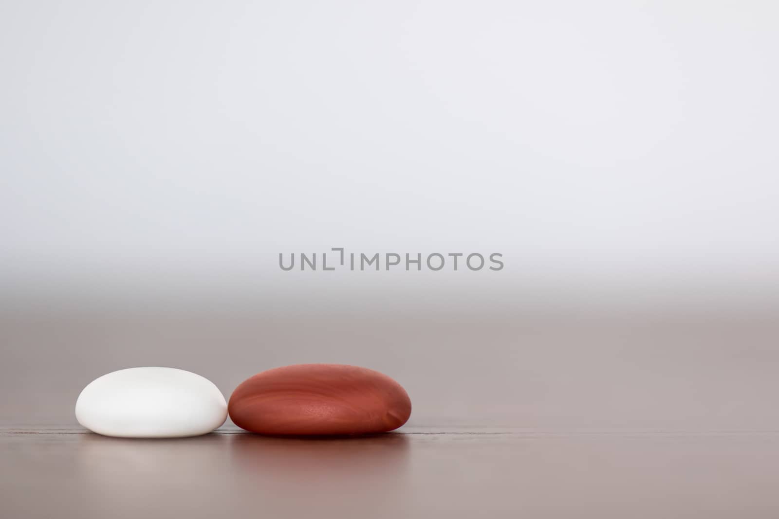 Minimalist picture of two soft shape stones, representing the union of a couple 