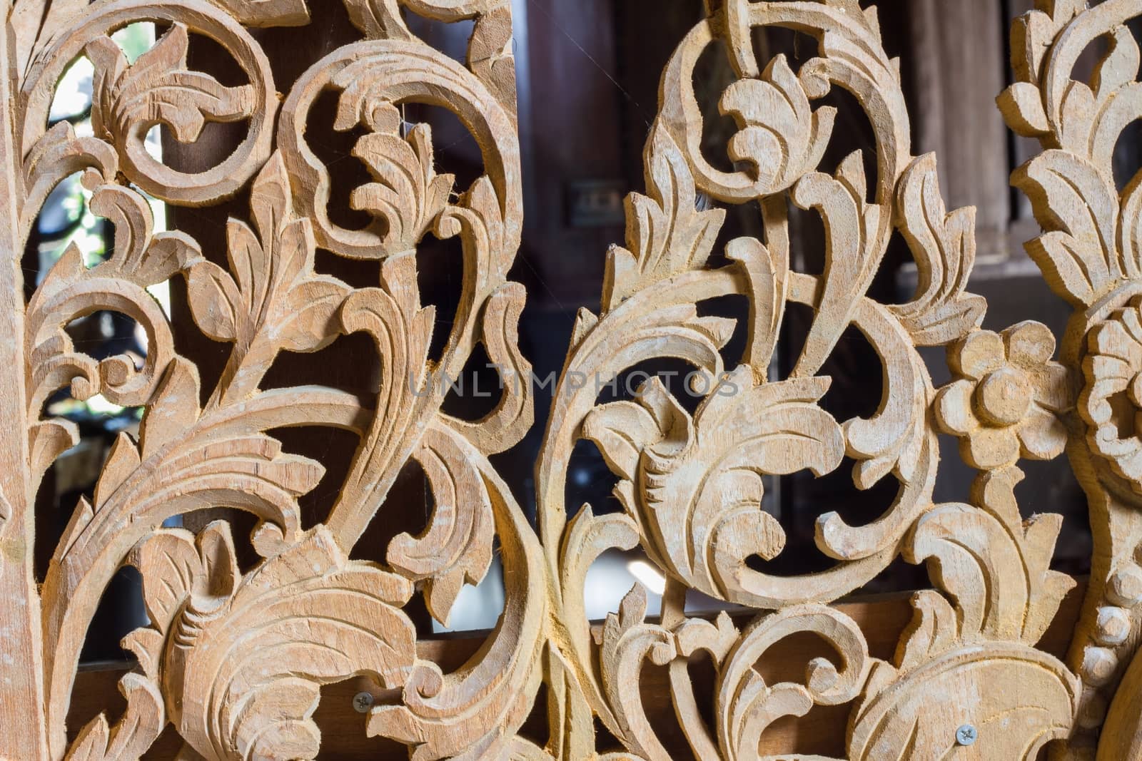 Pattern of flower carved on wood background.