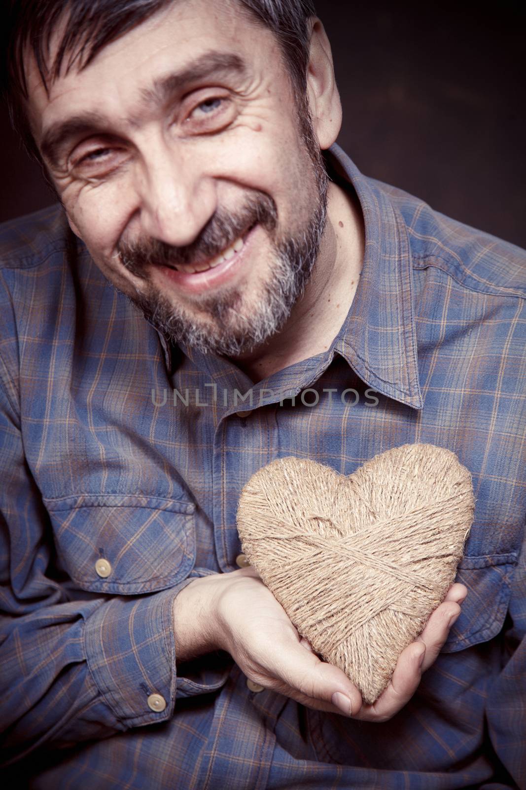Man holding heart in his hands by anelina